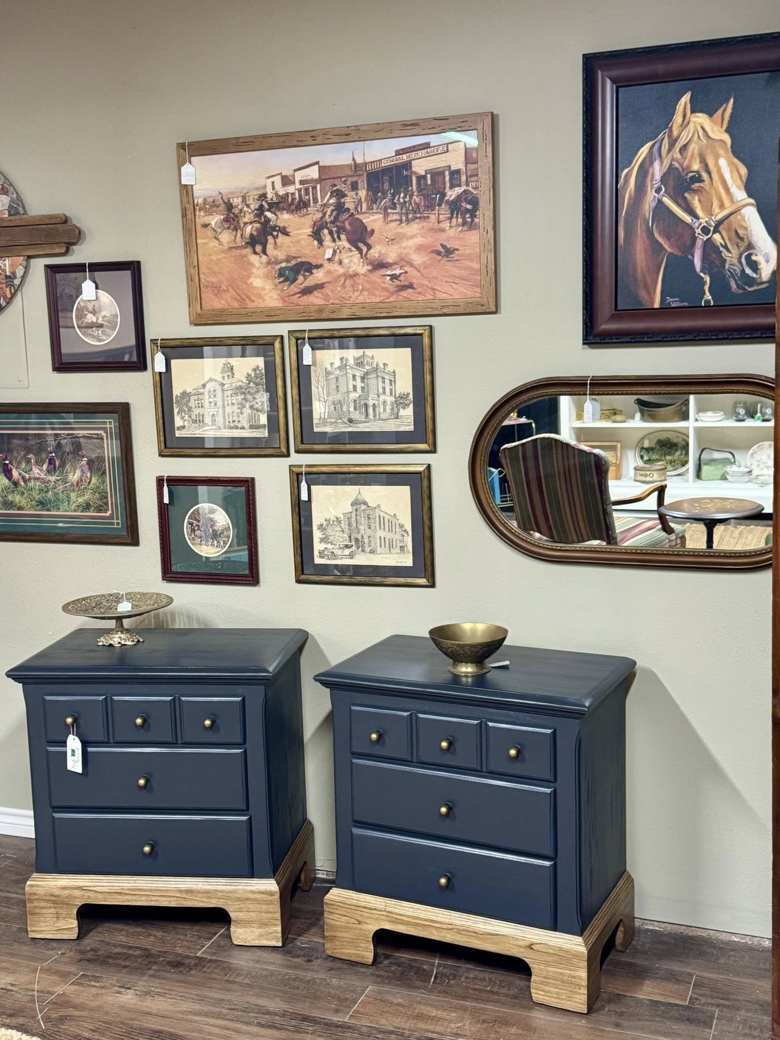 Blue painted nightstand pair styled with vintage wall art