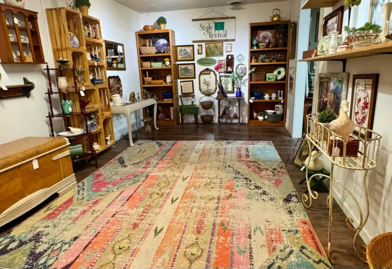 Looking down the length of the booth over a colorful rug