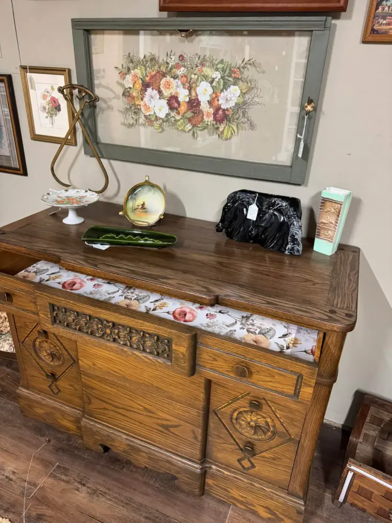 Carved oak buffet drawer lined in floral paper