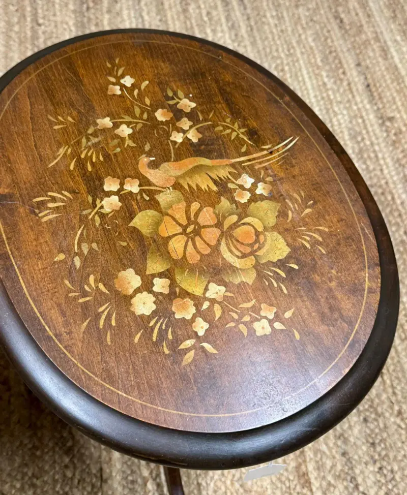 Inlaid bird and flowers on an oval tabletop