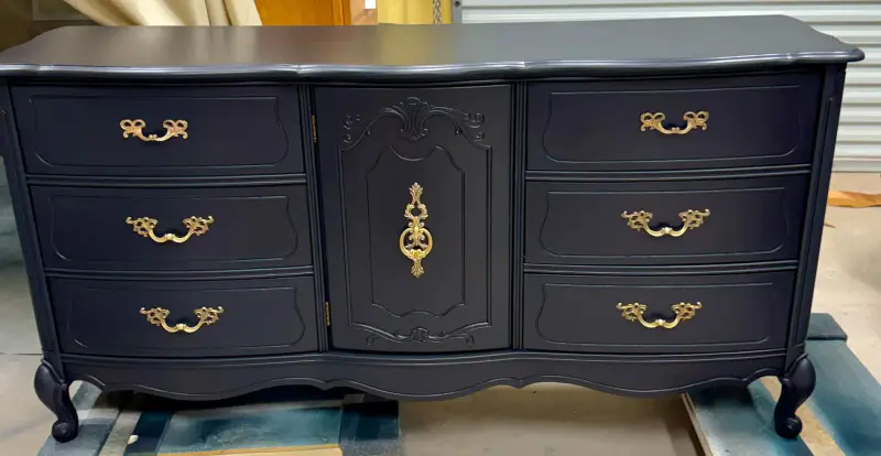 Vintage Bassett French Provincial dresser painted deep midnight blue with ornate brass pulls and a carved center door