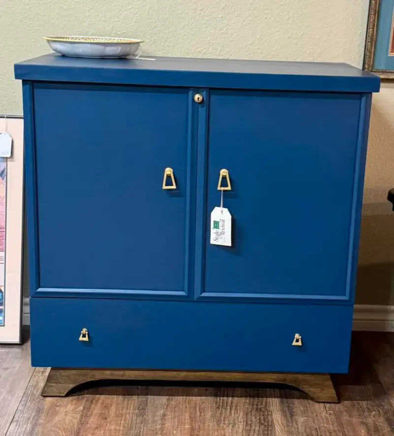 After: the same cabinet in deep navy with brass drop pulls