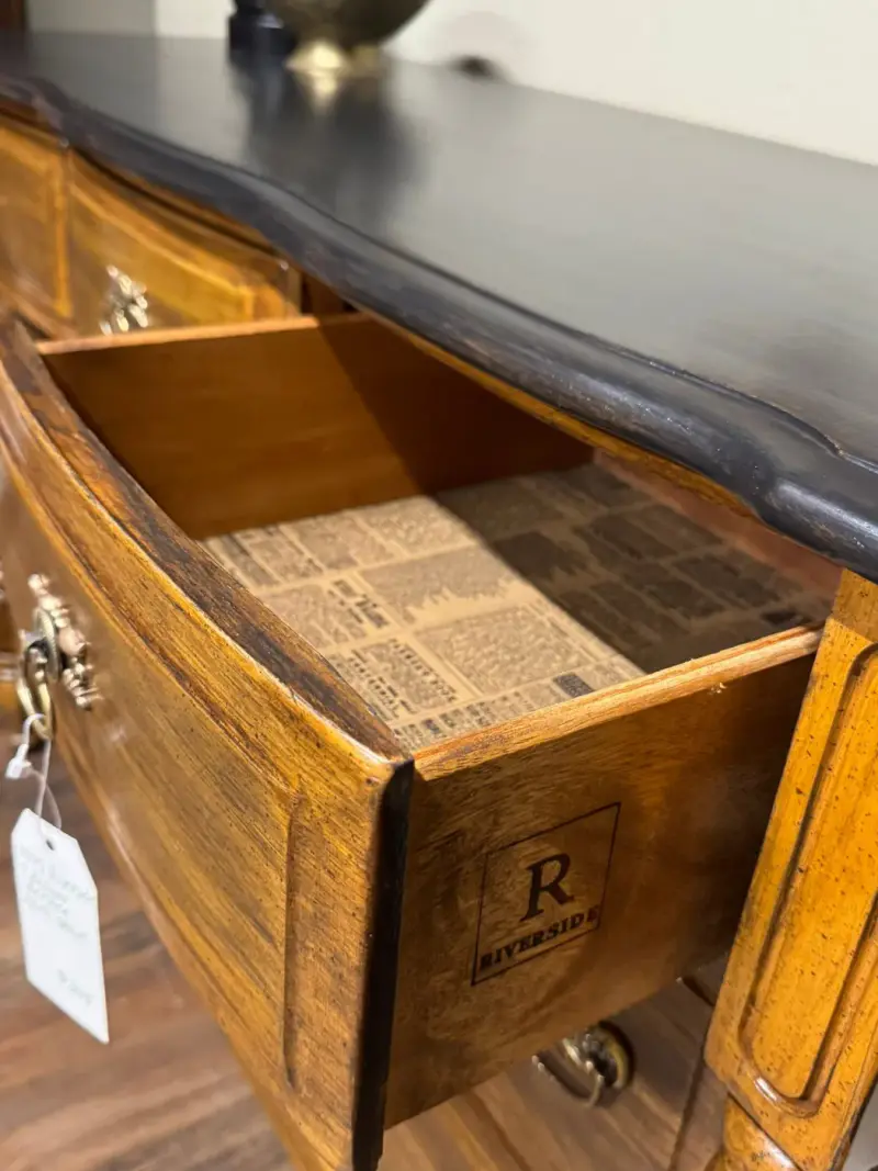 Drawer lined in vintage newsprint with the maker's mark