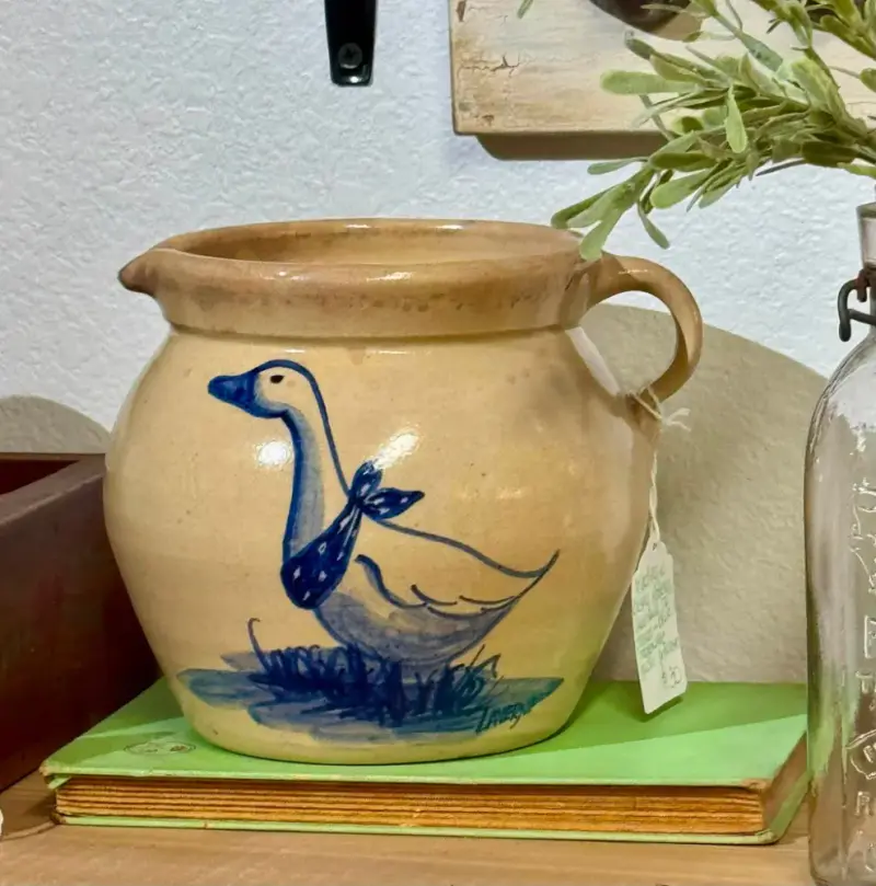 Speckled stoneware pitcher painted with a blue goose